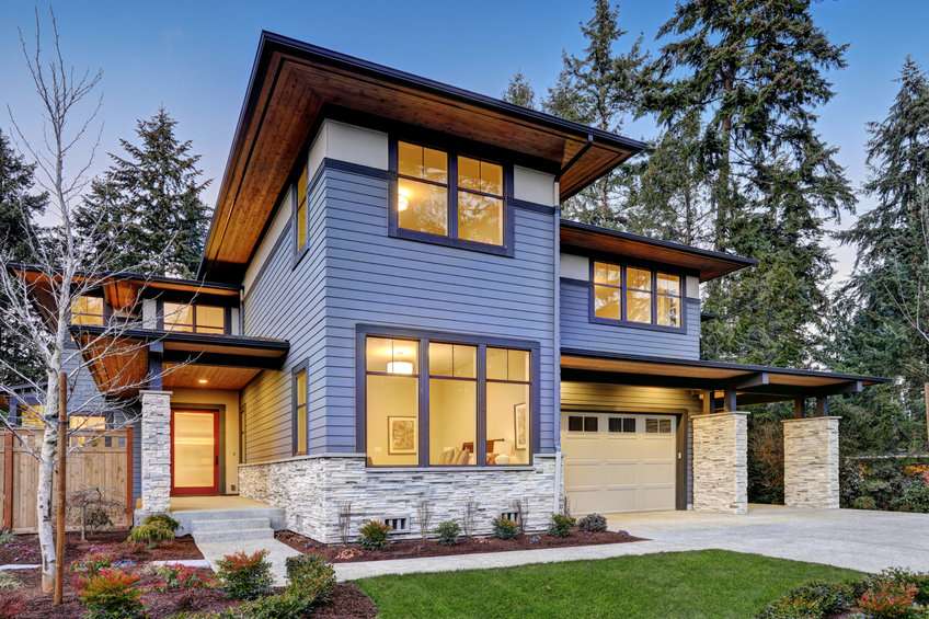 Luxurious new construction home in Bellevue, WA. Modern style home boasts two car garage framed by blue siding and natural stone wall trim. Northwest, USA