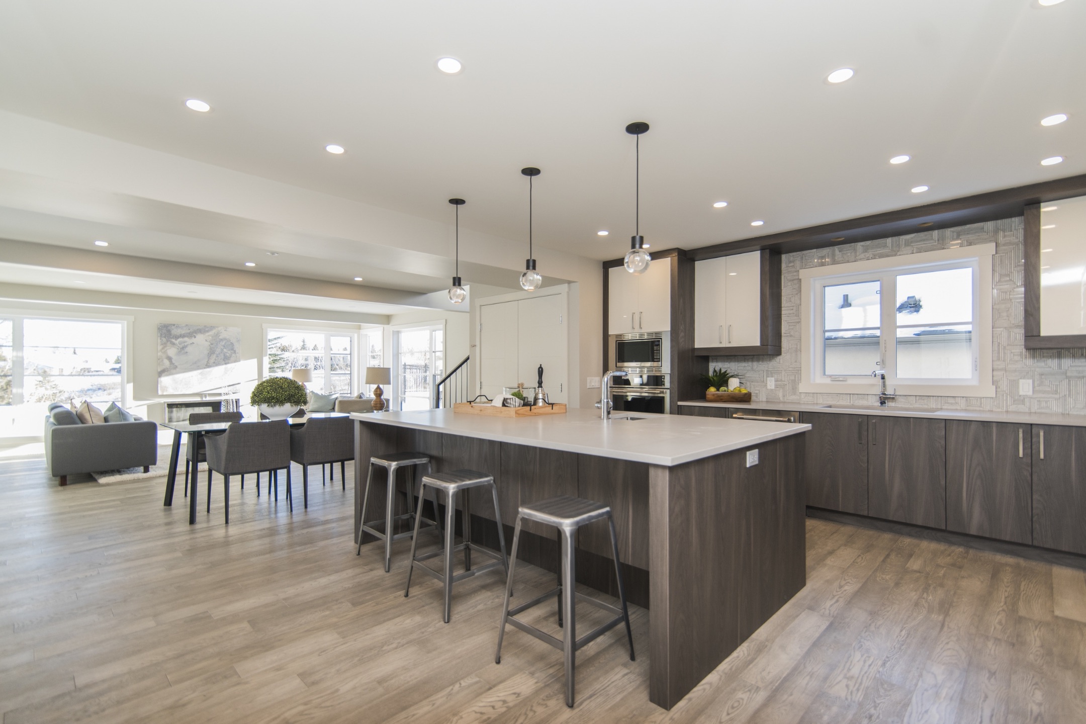 Modern kitchen with an island and laminate floors.