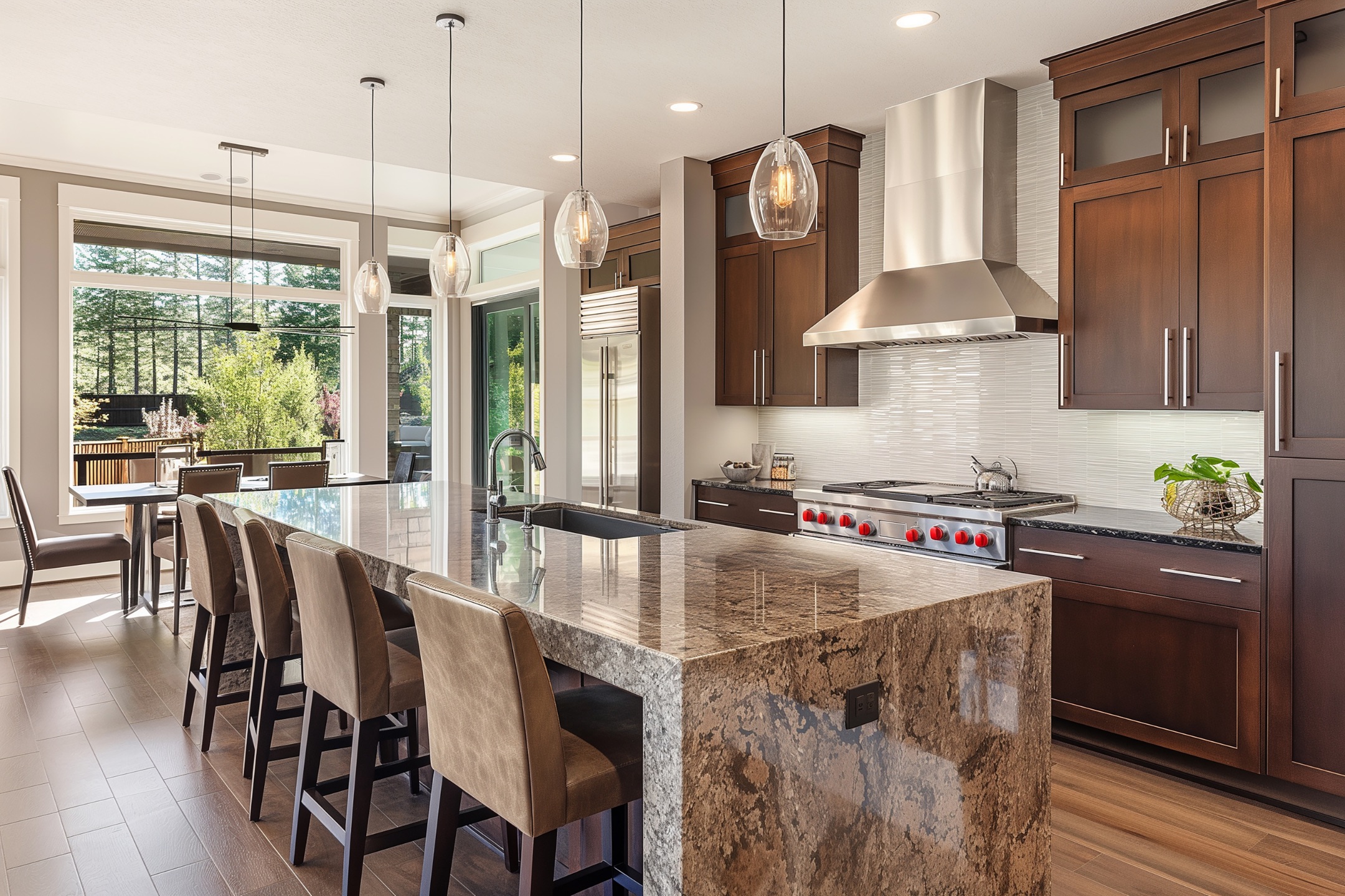 Luxurious modern kitchen remodel featuring a spacious marble island, sleek stainless steel appliances, and elegant pendant lighting, exemplifying Bayside Builders Group's expertise in Bay Area home renovations.