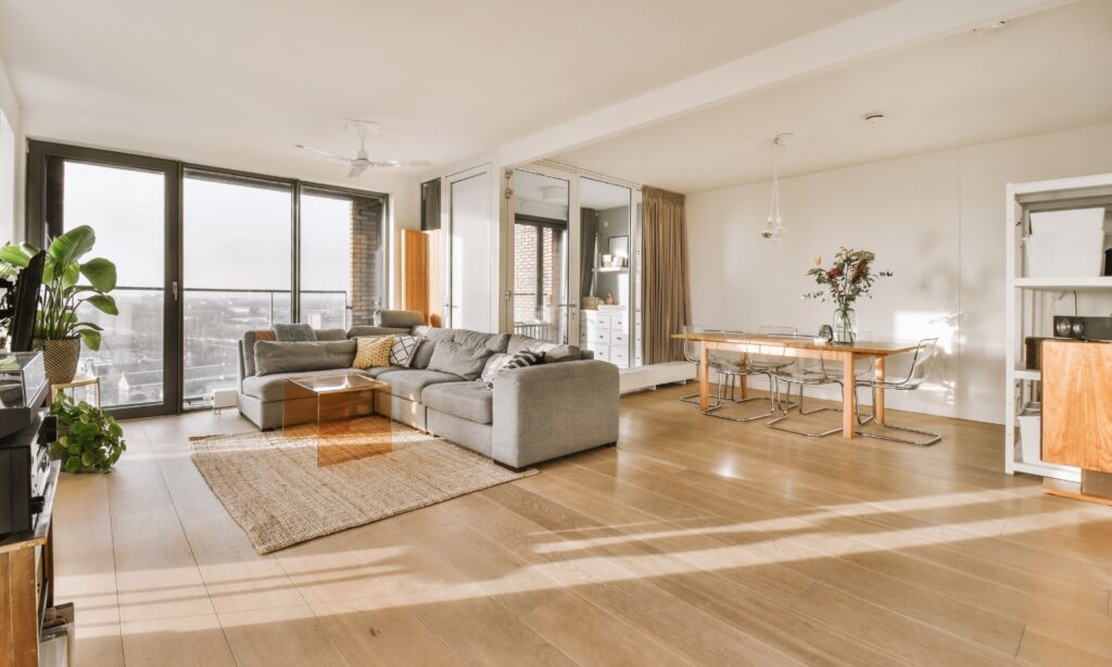 Spacious and modern living area with large windows, natural light, and elegant furnishings, ideal for showcasing expert remodeling by Bay Area construction professionals like Bayside Builders Group.