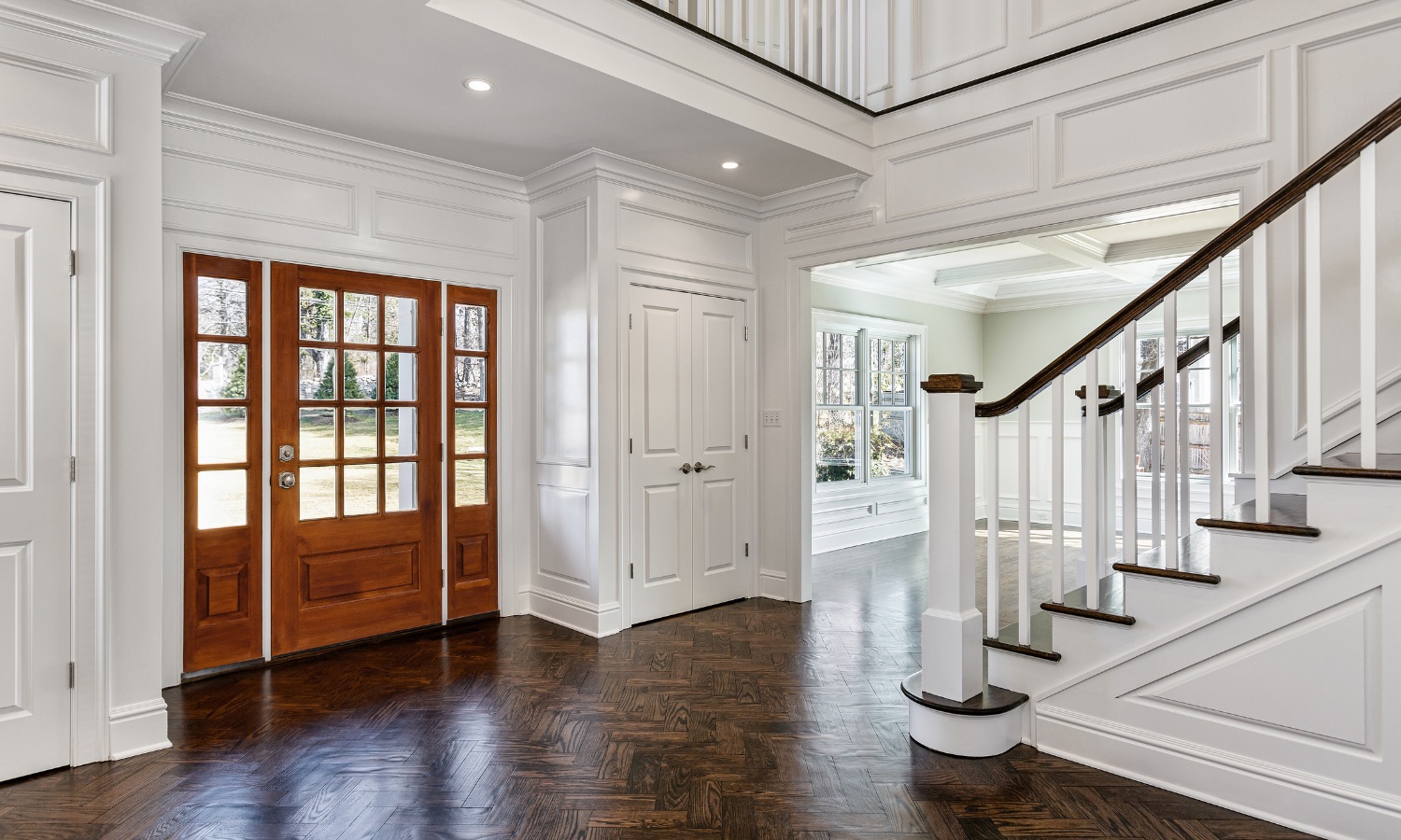 Elegant home entrance featuring a wooden door and classic staircase, showcasing Bayside Builders Group's expertise in Bay Area home renovations and stylish interior designs.